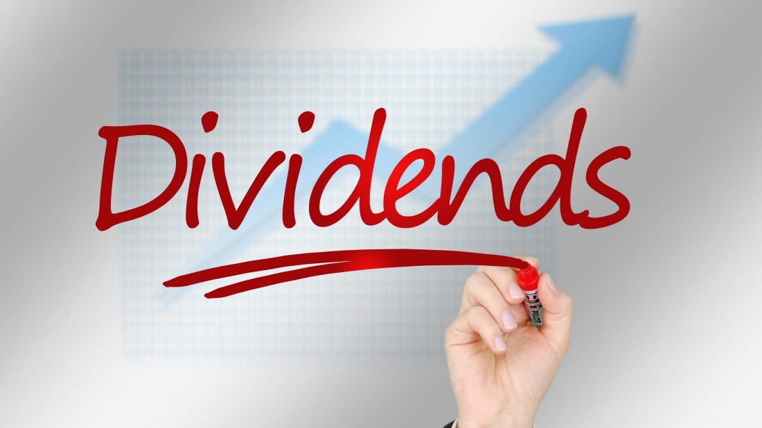Hand-with-marker-writing-Dividends